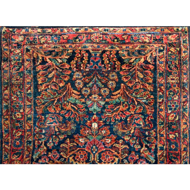 A gorgeous early 20th century Persian Sarouk rug with a large diamond floral medallion living admits a field of more...