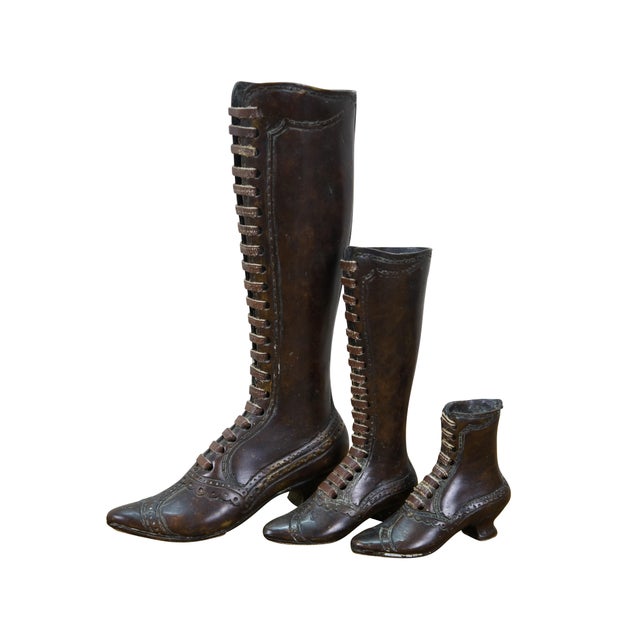 Set of six late 20th century Theodore Alexander bronze figurines in the shape of Victorian boots in a variety of heights...