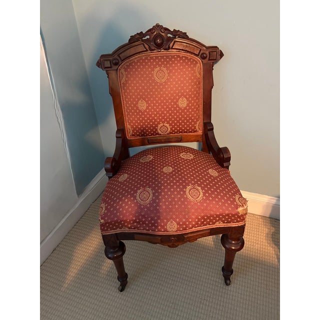 A matched pair of American/Victorian Renaissance Revival black walnut parlor chairs, circa 1870–1875, attributed to New...