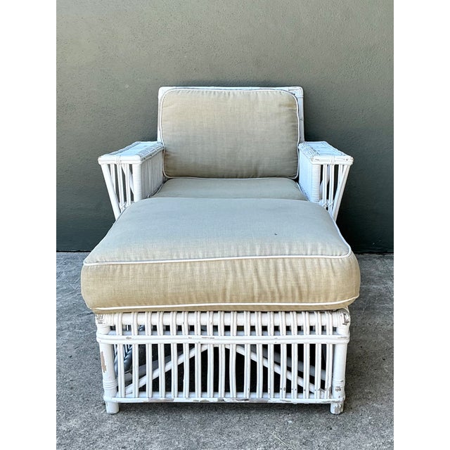 This vintage rattan lounge chair and ottoman, crafted in the style of Bielecky Brothers, embodies the relaxed...