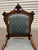 Beautifully carved Victorian Eastlake-style parlor chair made of walnut wood with upholstered back and seat.