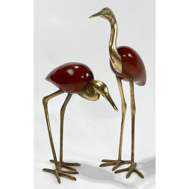 Unique pair of vintage rosewood and brass crane figures. Each features detailed brass head, neck, legs and feet with...