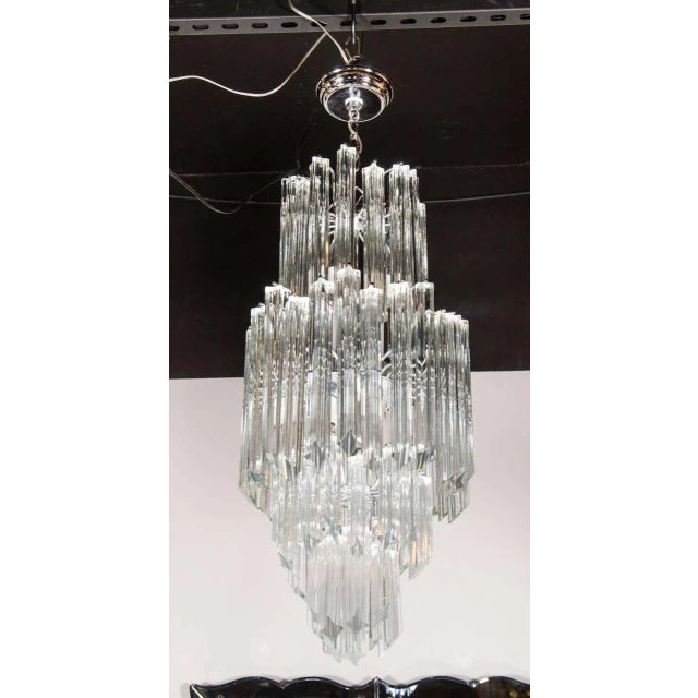 Mid-Century Modernist Skyscraper form four-tiered cut crystal triedre Camer chandelier. This chandelier features four...
