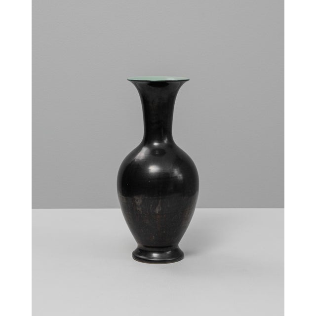 20th Century German Ceramic Vase. This elegant vase features a classic baluster form with a gently flared rim and narrow...