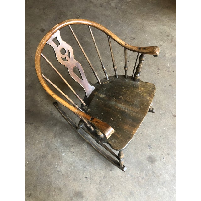 Windsor rocking chair with detailed back piece and spindles. See photos for the missing piece cracked off of the bottom...