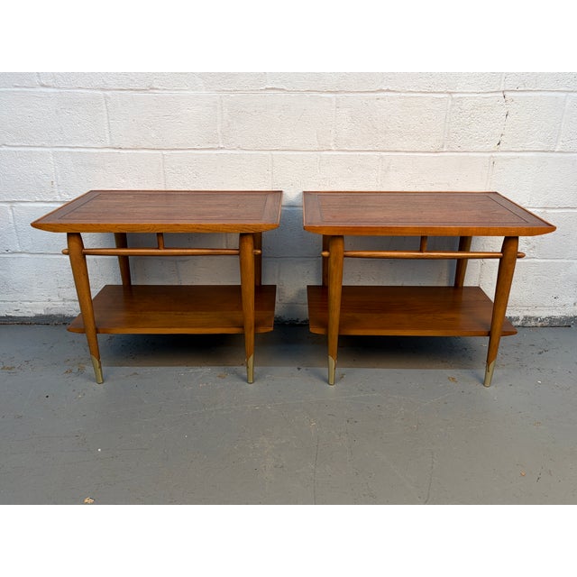 Add a touch of iconic American design to your home with this pair of Lane Alta Vista walnut and brass Mid-Century Modern...