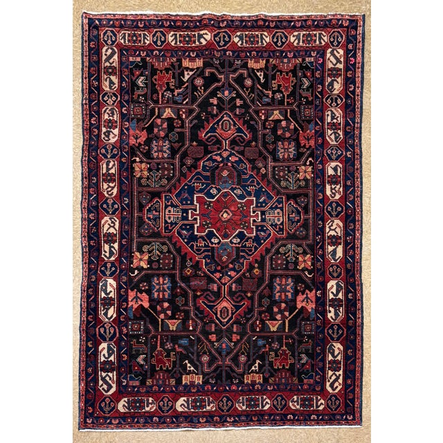 Antique hand-knotted rug from the Nahavand region of western Iran, featuring a bold central medallion set within a dark...