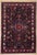 Antique hand-knotted rug from the Nahavand region of western Iran, featuring a bold central medallion set within a dark...