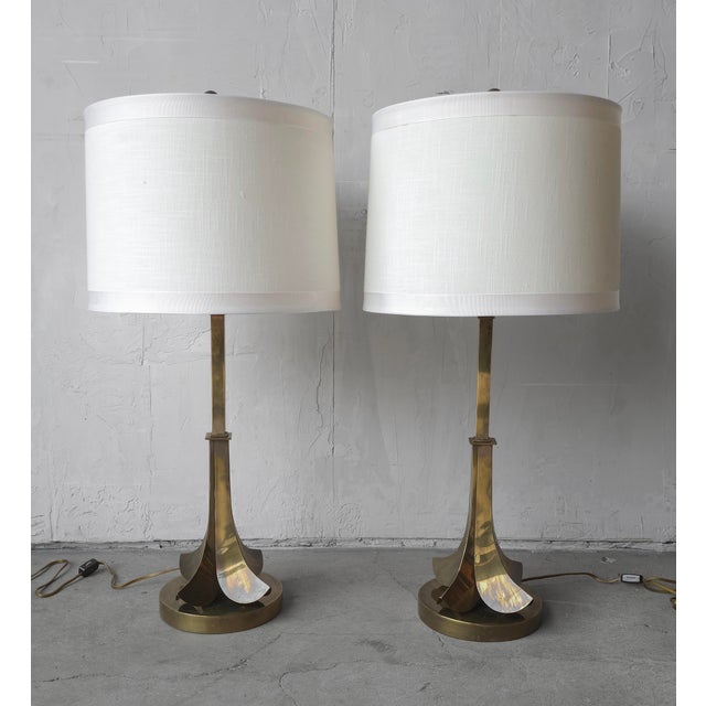 Stunning pair of sculptural brass table lamps by Hart Associates, featuring elegant flared petal bases and tall,...
