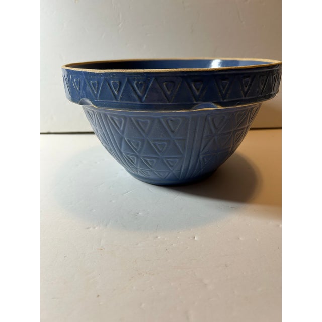 This a very unique vintage or antique, medium size stoneware mixing bowl in the delightful color glaze of periwinkle. The...