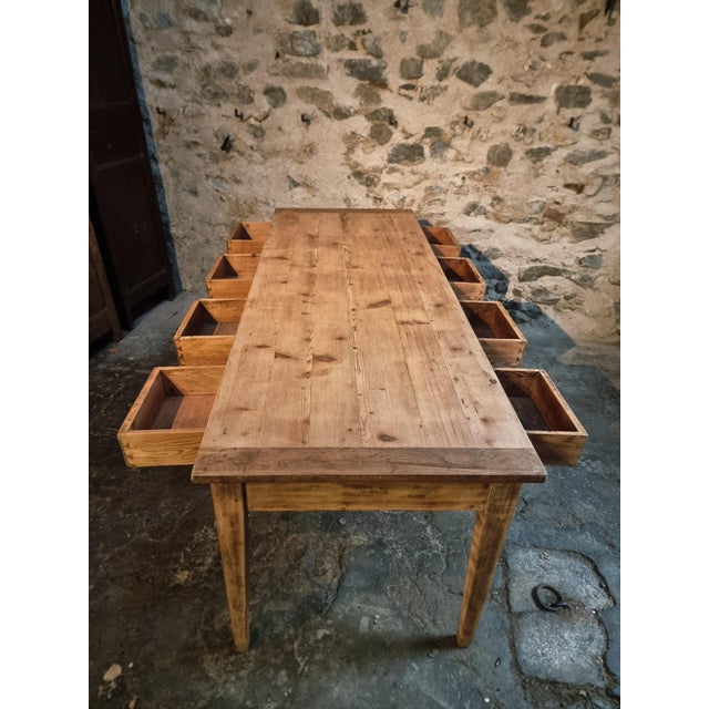 This antique French dining table and work table dates from around 1900. It combines traditional craftsmanship with...