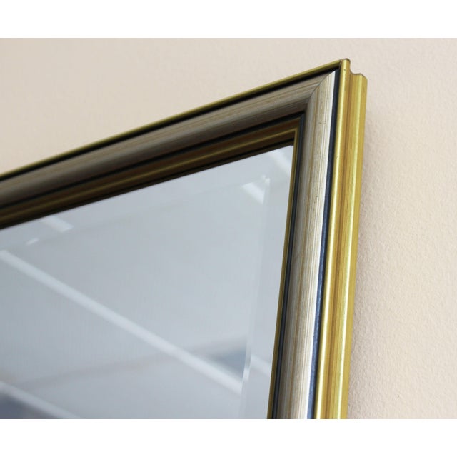 A rectangular, beveled Italian mirror from the 1960s. The beveled glass beautifully captures the light, creating subtle...