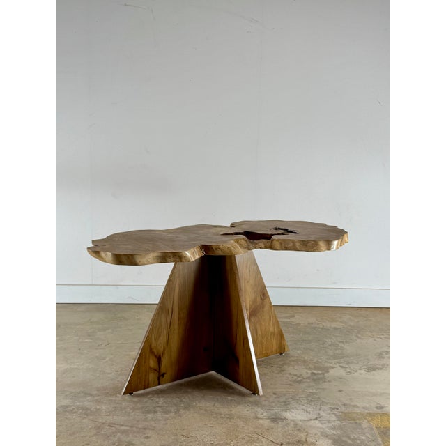 This handcrafted sculptural table is a one-of-a-kind functional artwork, defined by an organically shaped live-edge top...