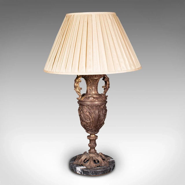 This is a large antique feature lamp. An Italian, gilt metal and marble heavy table light, dating to the late Victorian...