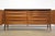 A mid century modern mahogany sideboard credenza designed by Paul McCobb for Calvin. Two trifold doors and a black marble...
