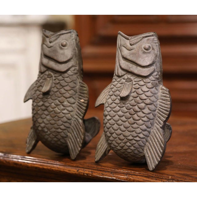 Crafted in France circa 1890 and made of bronze, each vessel depicts a bass fish standing on his tail and fins, and with...