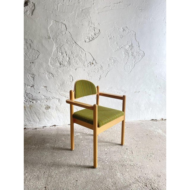 A refined set of solid beechwood armchairs reflecting the clean proportions and functionalist spirit of late 20th-century...