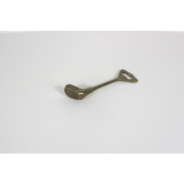 This is a vintage, solid brass bottle opener in the shape of a golf club or driver. Essential barware for any golfer. This...