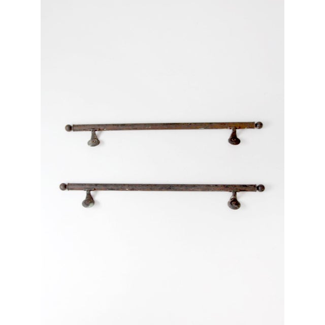Pair of antique early 20th-century iron handrails with substantial tubular rails, ball finials, and cast circular wall...