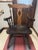 This is a mid 20th century Nichols & Stone arm chair. The Windsor style chair features a cut out center splat with spindle...