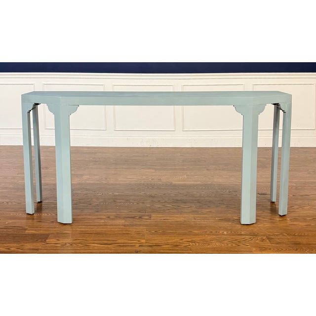 This is the Martin Console Table by Highland House. It has a contemporary design with a light blue color. We estimate it...