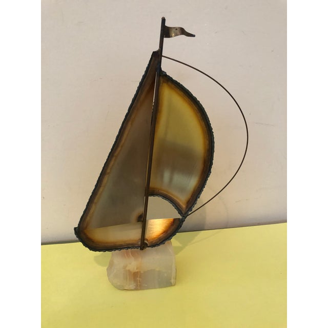 Signed metal sailboat sculpture on rock base. The signature appears to belong to Mario Jason. Great craftsmanship. This...