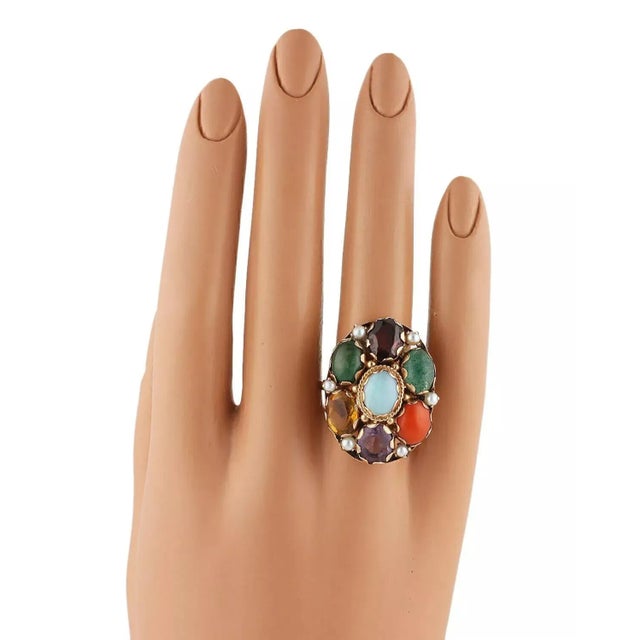This beautiful retro era ring is crafted from solid 14k yellow gold. The large oval shape top has 7 large oval gemstones...