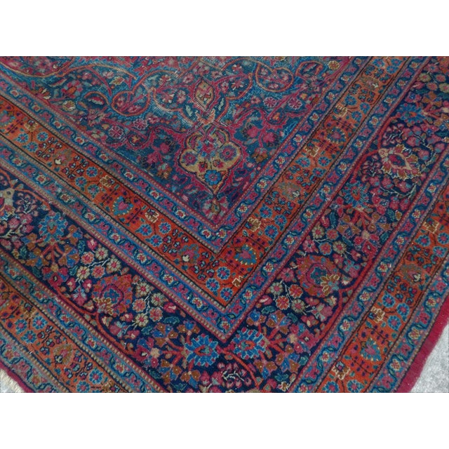 Central medallion with inner compartments surrounded by floral ornaments on a red wine field, within symmetrical...