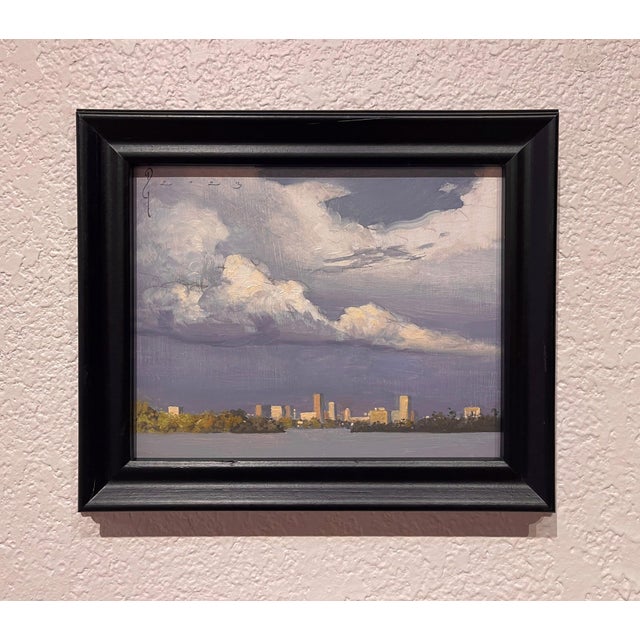 Sloan's Lake captures a tranquil urban landscape at dusk, where the soft hues of the sky blend seamlessly with the...