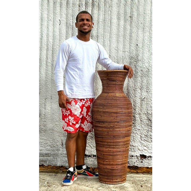 Vintage coastal pencil reed floor vase featuring a tall, sculptural silhouette with intricately woven natural reed...