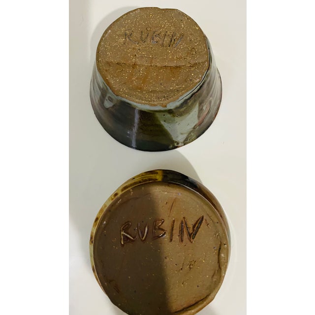 These items are signed vintage studio pottery bowls featuring a dark brown glaze with variegated tones. It is designed for...