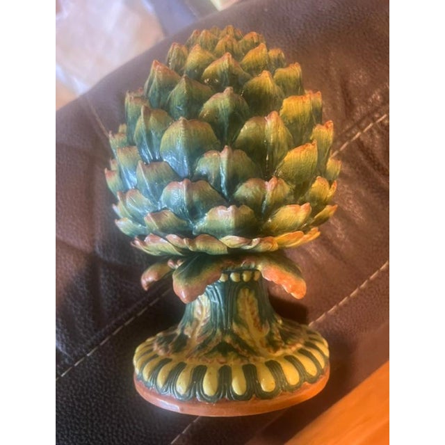 This decorative piece is crafted in the shape of a blooming artichoke, featuring realistic, layered leaf scales with a...