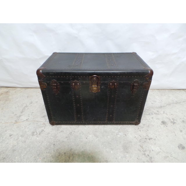 This is an Antique Wood and leather covered Traven Trunk. its missing the upper shelf.
