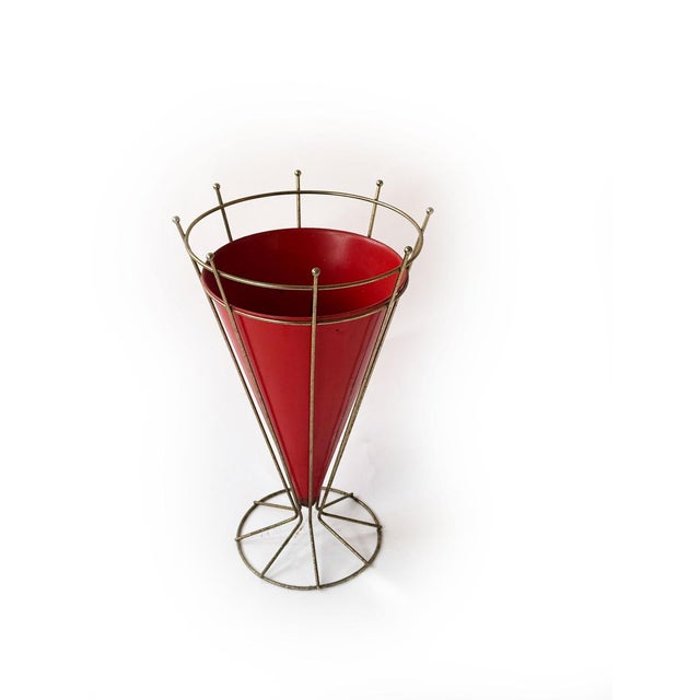 This exceptional umbrella stand from the 1950s–60s combines clean lines with striking color. The conical red lacquered...