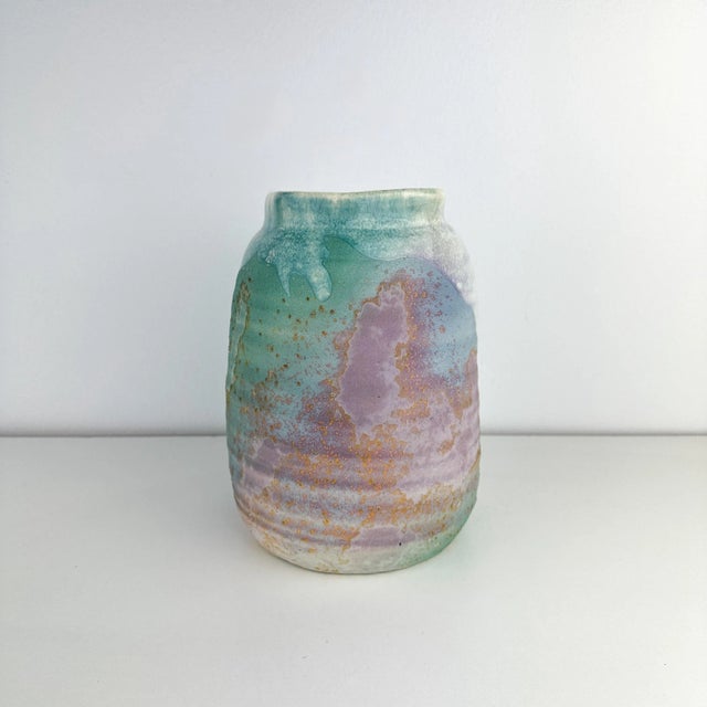 Vintage circa 1980s roku pottery vase by Tony Evans. Teal and purple hues with textured glaze finish. Square opening and...
