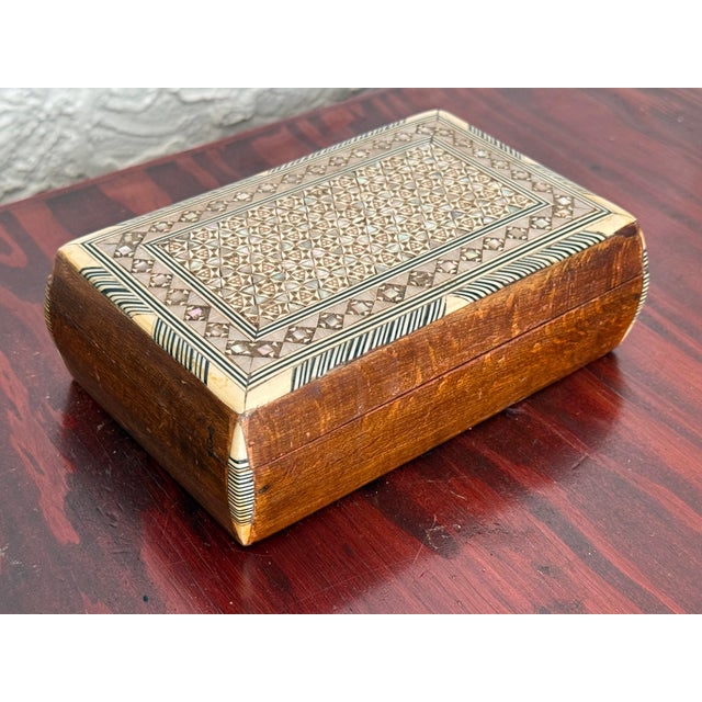 Vintage wooden box with a hinged lid and fine micro mosaic inlay. The lid shows a dense geometric pattern of tiny stars...