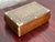Vintage wooden box with a hinged lid and fine micro mosaic inlay. The lid shows a dense geometric pattern of tiny stars...