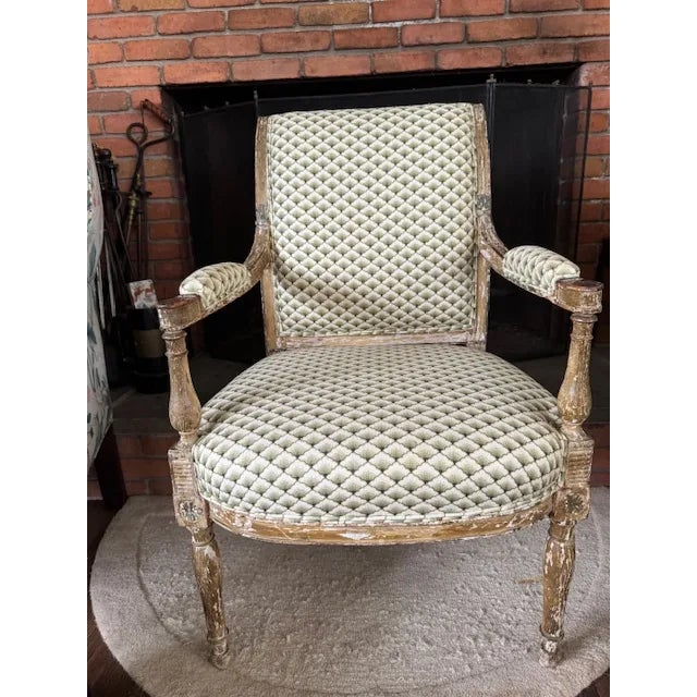 Pair of antique French Louis XVI–style bergère chairs from the late 19th century, featuring carved, painted, and giltwood...