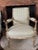 Pair of antique French Louis XVI–style bergère chairs from the late 19th century, featuring carved, painted, and giltwood...