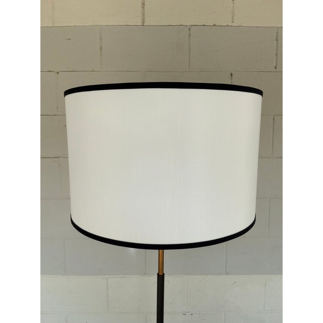 Currey & Co Willoughby Floor Lamp. Skinny brass body with black accents. X shape body, drum shade with black bands....