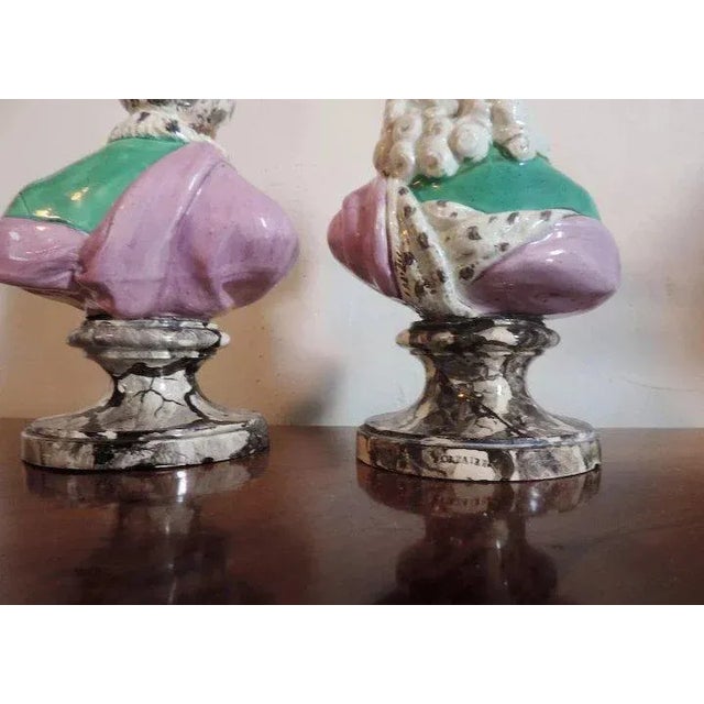 Pair 18th c. creamware figures of philosophers Voltaire and Rousseau. Each decorated in bright polychrome palette and...