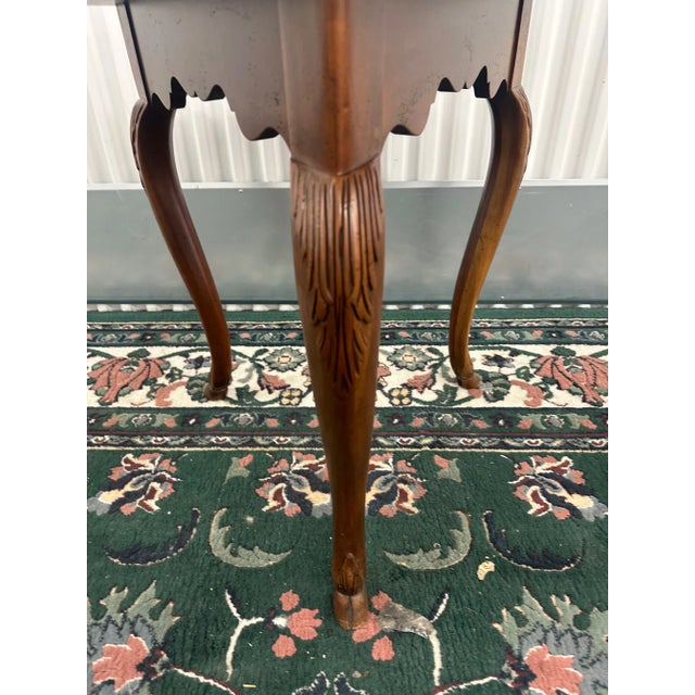 The BAKER Cherry Inlaid Clover Leaf Side Table exudes elegance with its exquisite craftsmanship and timeless design....