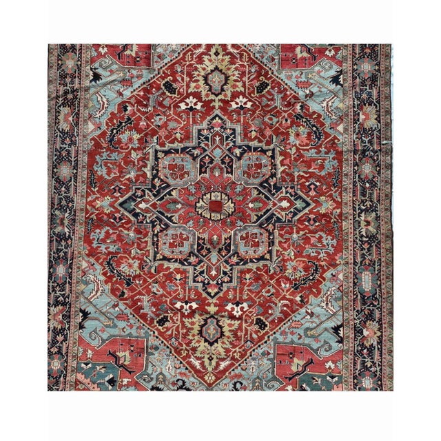 Antique hand-knotted Heriz/Serapi wool rug, circa 1880–1900, with a brick-red field and a large geometric central...