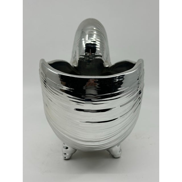 Eye catching silver high gloss ceramic nautilus. It looks like sterling but without the need to polish. Great detail,...
