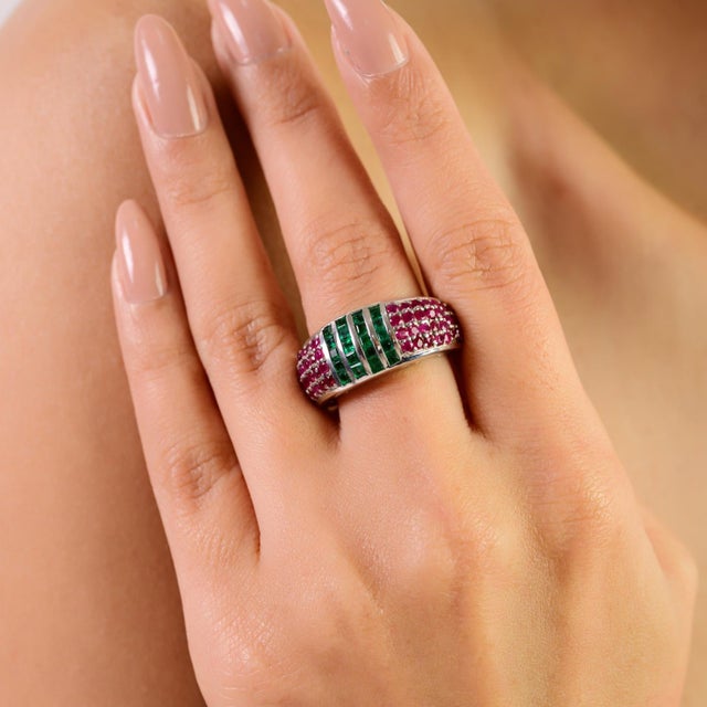 Art Deco–inspired statement dome band ring crafted in 925 sterling silver, featuring natural emerald and ruby gemstones in...