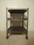 Metal shelving unit on casters restored in a bare metal style finish. Handsome industrial look with exposed rivets. Makes...