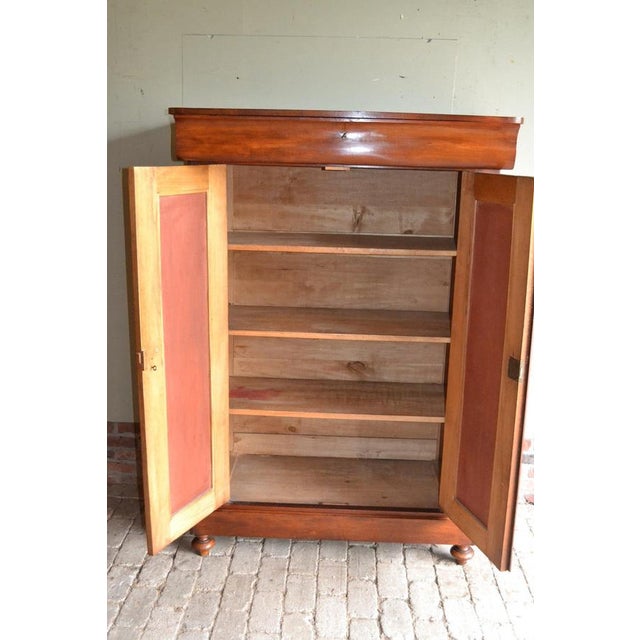 19th-century Dutch mahogany girls' cabinet. The height is 159 cm. The width is 111 cm. The depth is 52 cm. A drawer at the...