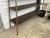 Dated from the mid 20th century. Rustic industrial self. Metal frame with built in wood shelfs. Tapers from bottom to top....