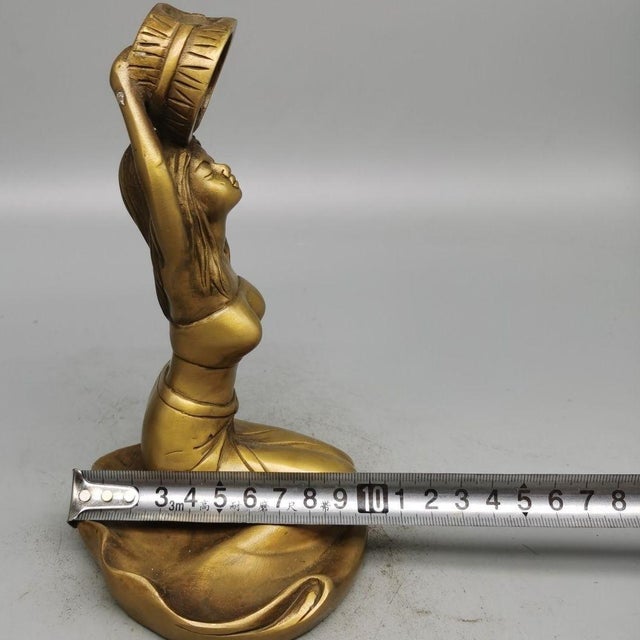 This elegant vintage incense holder is crafted from polished brass, featuring a beautifully modeled figure of a kneeling...