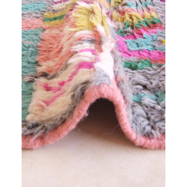 Transform your space with the vibrant beauty of this handwoven Moroccan Berber rug, a captivating fusion of traditional...